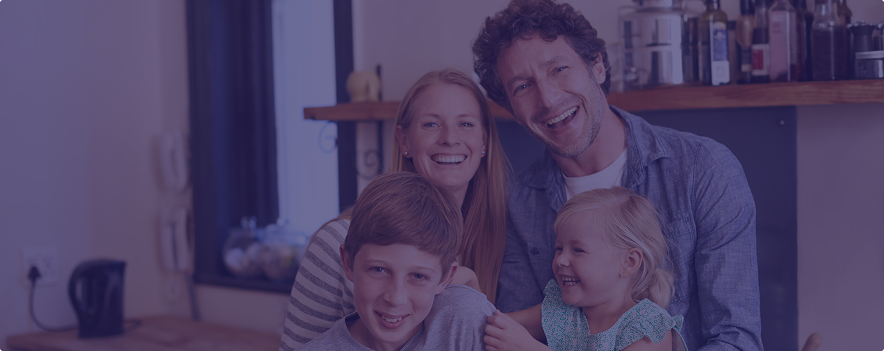 Family smiling and posing for family photograph
