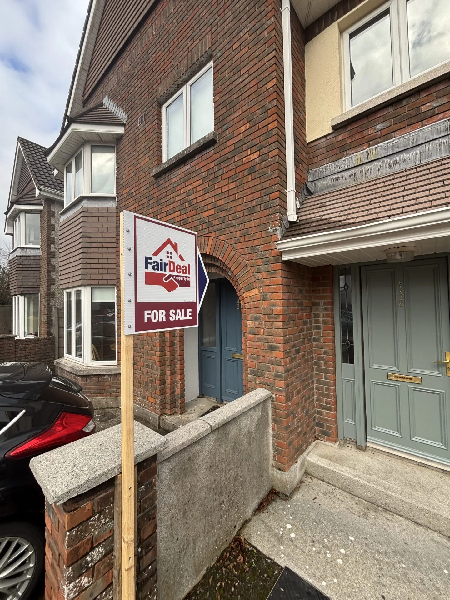 Exterior of Irish home with Fair Deal signage outside.